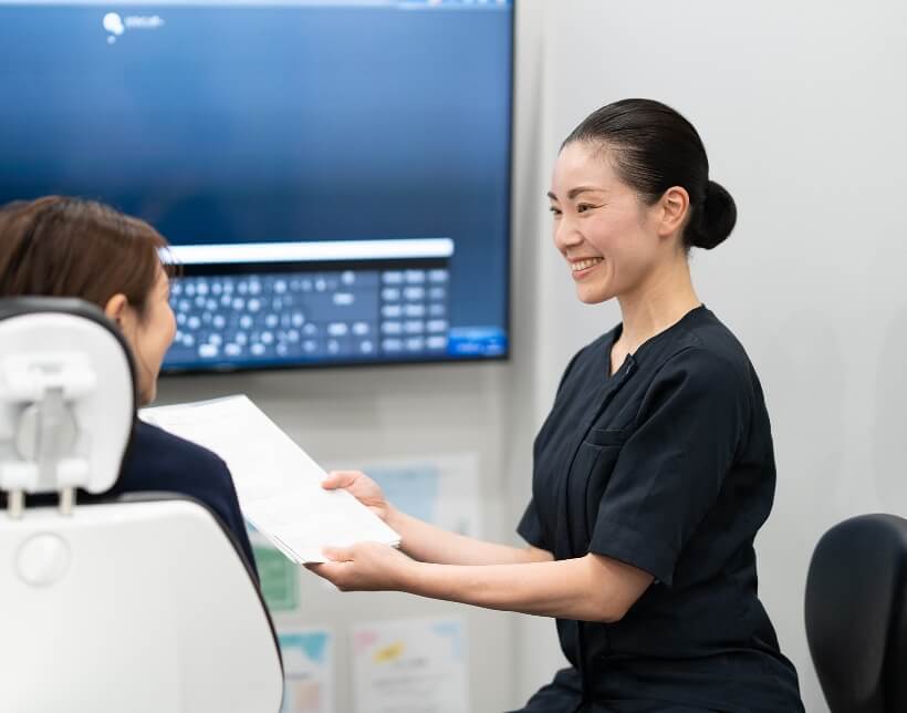 患者さまと治療について話す歯科医師の大金さん